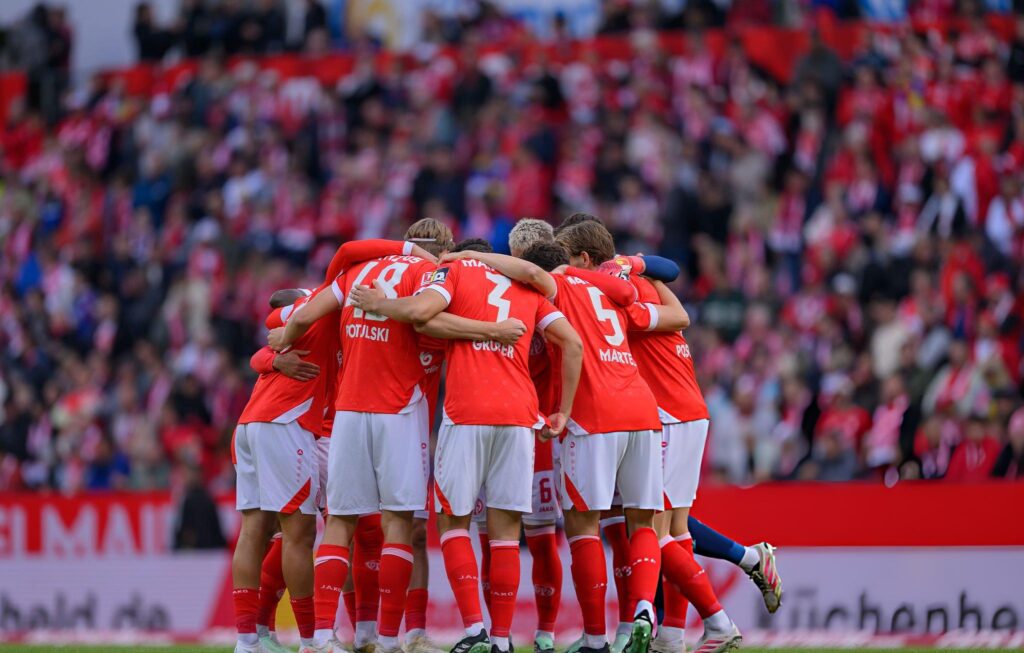 Mainz 05 Players Gather in a Pre Match Huddle