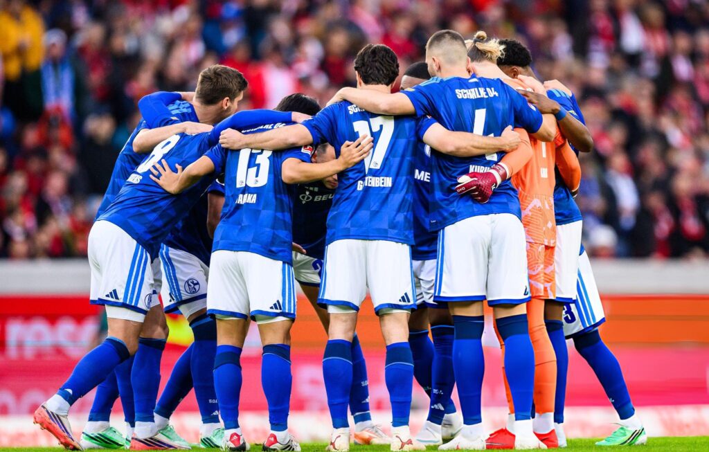 Schalke 04 Players Gather for a Pre Match Huddle